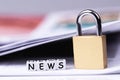 Newspaper, cubes with word News and metal lock Royalty Free Stock Photo