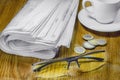 Newspaper cup of coffee and glasses on the table Royalty Free Stock Photo