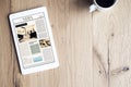 Newspaper on digital tablet on wooden table Royalty Free Stock Photo