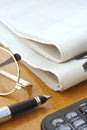 Newspaper, Glasses, Pen and Calculator Royalty Free Stock Photo