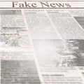 Newspaper with headline Fake News and old unreadable text Royalty Free Stock Photo