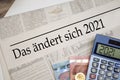 Newspaper with money and calculator and german headline Changes coming in 2021 - das ÃÂ¤ndert sich 2020 Royalty Free Stock Photo