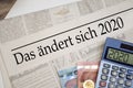 Newspaper with money and calculator and german headline Changes coming in 2020 - das ÃÂ¤ndert sich 2020 Royalty Free Stock Photo