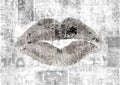 Newspaper with old grunge vintage unreadable paper texture background and woman`s lipstick kiss