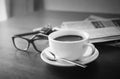 Newspaper reading glasses black and white coffee cup and mobile Royalty Free Stock Photo
