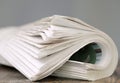 newspaper rolled up and sitting on a table no people stock photo Royalty Free Stock Photo