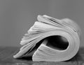 newspaper rolled up and sitting on a table no people stock photo Royalty Free Stock Photo