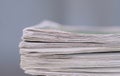 newspaper rolled up and sitting on a table no people stock photo Royalty Free Stock Photo