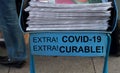 Newspaper stack with shout out covid-19 virus curable