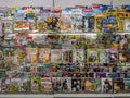 Newspaper stand with assorted magazines. Popular Magazines and Journals on a book shelf at a Store.