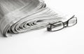 Newspapers with eyeglasses on white background Royalty Free Stock Photo