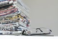 Newspapers with eyeglasses on white background Royalty Free Stock Photo