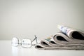 Newspapers with eyeglasses on white background Royalty Free Stock Photo