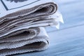 Newspapers folded and stacked on the table