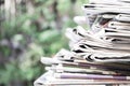 Newspapers folded and stacked on the table with garden. Closeup newspaper and selective focus image.Time to read concept Royalty Free Stock Photo