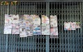 Newspapers hanging on steel door in the morning