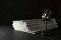 Newspapers and vintage microphone on stone table. Journalist`s work