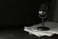 Newspapers and vintage microphone on dark stone table, space for text. Journalist`s work Royalty Free Stock Photo