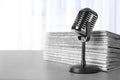 Newspapers and vintage microphone on grey table, space for text Royalty Free Stock Photo