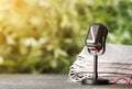 Newspapers and vintage microphone on table against blurred background, space for design. Journalist`s work Royalty Free Stock Photo