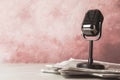 Newspapers and microphone on table, space for design. Journalist`s work