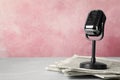 Newspapers and vintage microphone on table, space for text Royalty Free Stock Photo