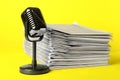 Newspapers and vintage microphone on background. Journalist`s work Royalty Free Stock Photo