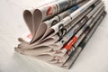 Newspapers on white wooden background Royalty Free Stock Photo