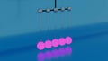 Newton Cradle or a desk toy pendulum, slow motion. Design. Close up of abstract balancing Newton balls creating relaxing