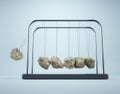 Newton\'s cradle made of rocks. Vicious cycle and strong ideas concept