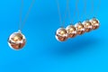 Newtons Cradle on a Blue Background Royalty Free Stock Photo