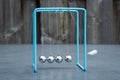 Newtons cradle, physics experiment: collision balls in action. Blurred motion.