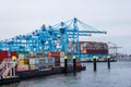 New container terminal with a large container ship and in the foreground a smaller inland container ship in the port of Rotterdam