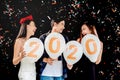 2020 Newyear party ,celebration party group of asian young people holding balloon numbers 2020 happy and funny concept