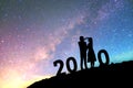 2020 Newyear Silhouette young couple Happy for romantic background on the Milky Way galaxy pointing on a bright star Royalty Free Stock Photo