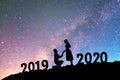 2020 Newyear Silhouette young couple Happy for romantic background on the Milky Way galaxy pointing on a bright star Royalty Free Stock Photo