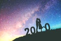 2020 Newyear Silhouette young couple Happy for romantic background on the Milky Way galaxy pointing on a bright star Royalty Free Stock Photo