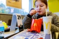 Girl holding and eating french fries in McDonald's restaurant