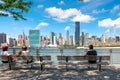 NewYorkers at a park in Queens with a view of midtown Manhattan