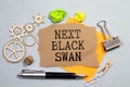 Next black swan symbol. Wooden blocks with words 'Next black swan'. Beautiful grey background, copy space. Royalty Free Stock Photo