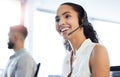 Next caller please. an attractive young call centre agent sitting in the office with her colleague. Royalty Free Stock Photo