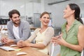 Next generation techies. Shot of a group of young businesspeople enjoying a laugh together at their desk.