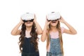 The next generation of virtual reality. Little girls wearing virtual reality headsets. Small children using virtual