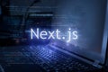 Next.js inscription against laptop and code background Royalty Free Stock Photo