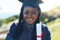 The next step is to make a success of my career. Portrait of a young student holding her diploma on graduation day. Royalty Free Stock Photo