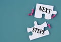 NEXT STEPS concept on mosaic puzzles on a dark green background Royalty Free Stock Photo