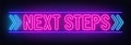 Next steps neon sign on brick wall background. Royalty Free Stock Photo