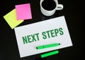 next steps paper sticky notes green marker coffee reflections Royalty Free Stock Photo