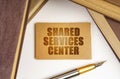 Next to the books lies a pen and a sign with the inscription - Shared Services Center Royalty Free Stock Photo