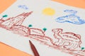 Next to the colored markers is a primitive children`s drawing with a felt-tip pen on a peach background. child development. Royalty Free Stock Photo